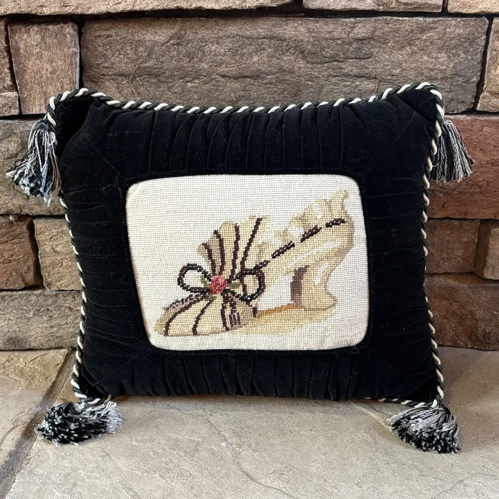 Needlepoint shoe and black velvet pillow with tassels
